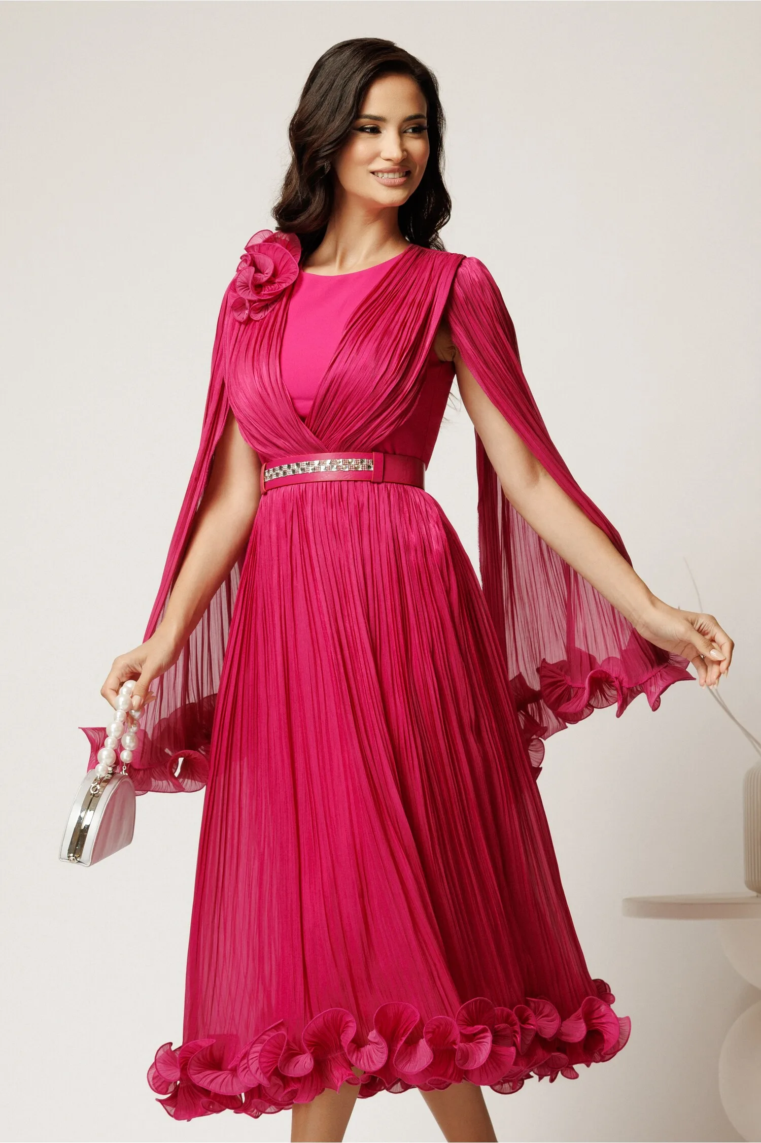 Rochie midi fucsia din voal satinat in clos cu floare la bust si curea din strasuri in talie