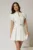 Rochie DY Fashion alba cu buline bleu cu fusta scurta cu pliuri si decolteu