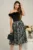 Rochie DY Fashion neagra cu imprimeu pe fusta si pene la bust
