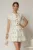 Rochie DY Fashion scurta alba cu floricele si fusta cu pliuri