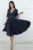 Rochie eleganta cu croiala in clos prevazuta cu maneca scurta cu design deosebit si nasturi pretiosi