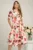 Rochie mid ivory din stofa in clos cu imprimeu floral roz si cordon in talie