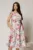 Rochie midi bej cu flori fucsia bleu in clos cu buzunare si curea in talie