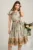 Rochie midi bej din satin in clos cu imprimeuri kaki si cordon in talie