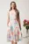 Rochie midi cu flori pastelate in clos cu buzunare si curea in talie