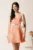Rochie scurta orange in clos cu model floral 3D si curea in talie