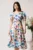 Rochie vaporoasa din satin alba cu flori colorate
